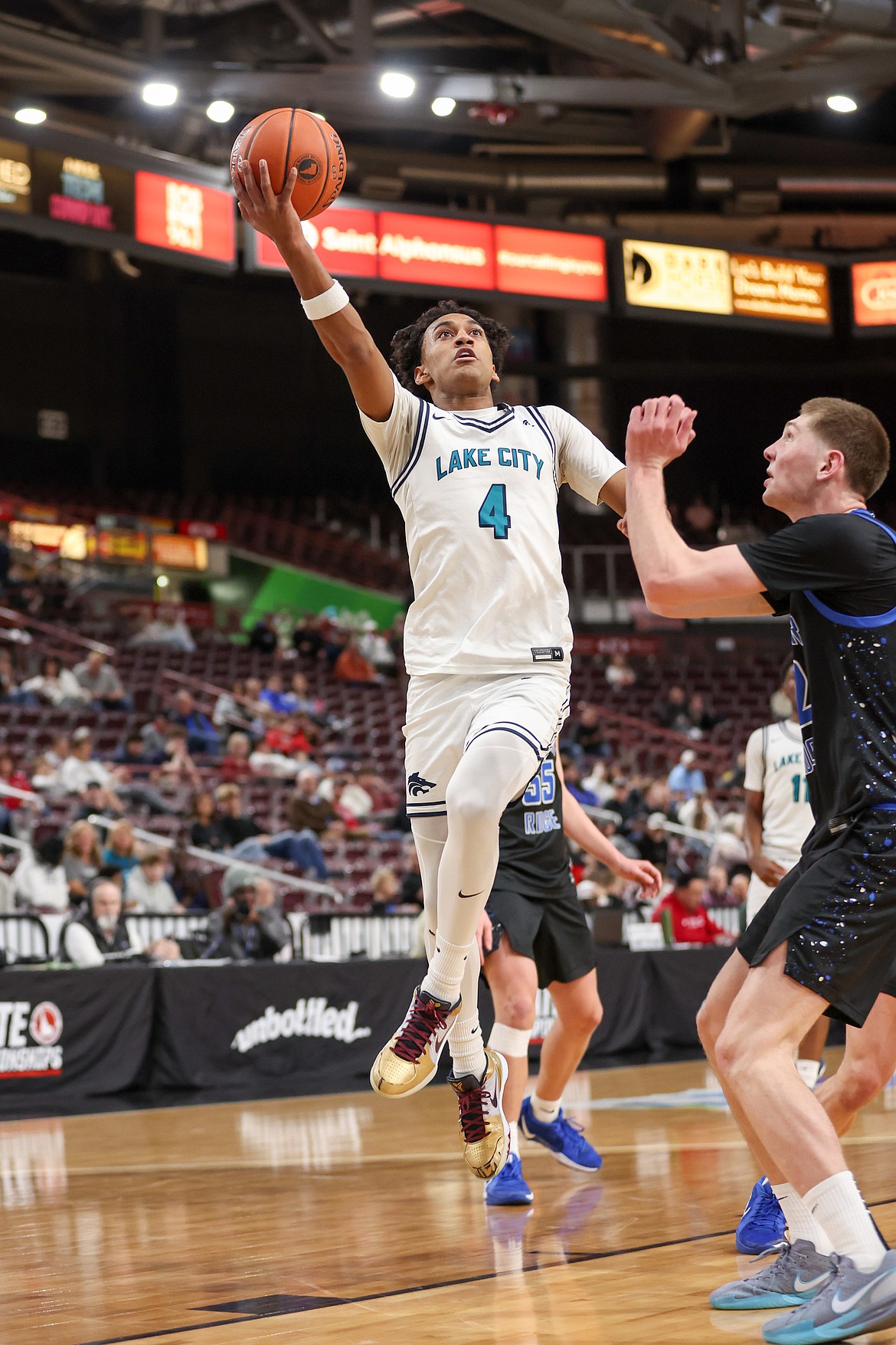 JASON DUCHOW PHOTOGRAPHY
Lake City senior Cason Miller (4) goes up for a shot against Thunder Ridge on Thursday in the first round of the state 6A boys basketball tournament at the Ford Idaho Center in Nampa.