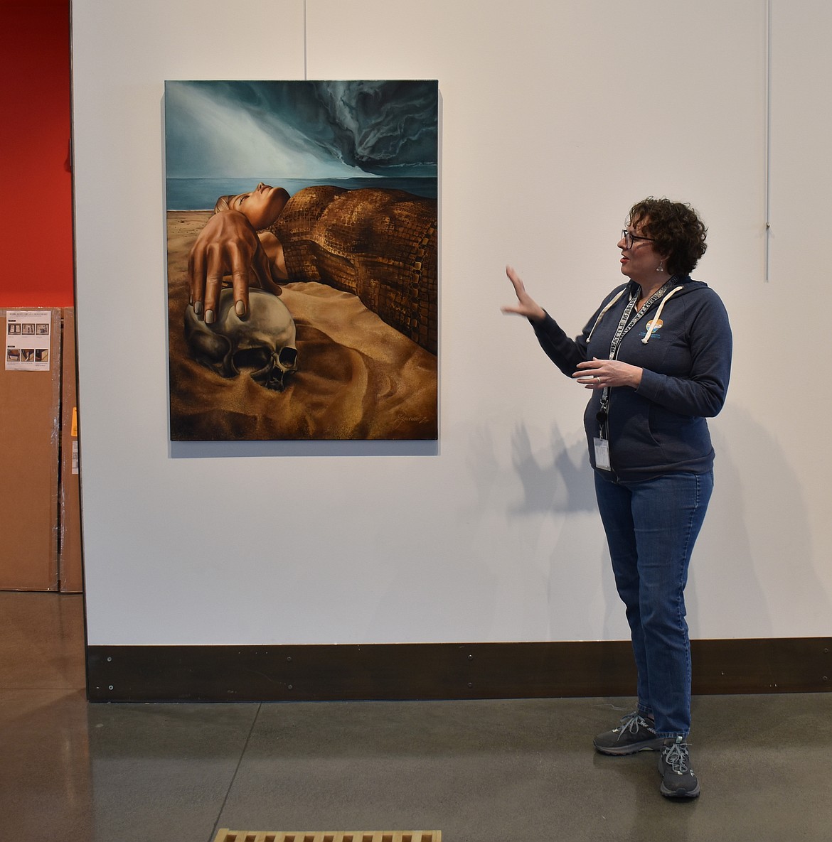 Moses Lake Museum & Art Center Director Dollie Boyd shows “Past Lives,” an oil painting  from Patricia Jensen’s “A Road Less Traveled” exhibit opening Friday at the museum.