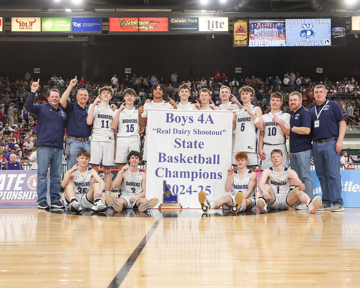 The Bonners Ferry High boys basketball team celebrates after winning the 2025 4A State Championship with a 65-51 win over Snake River. Back row, from left, are assistant coach Jed Bateman, head coach Nathan Williams, Peyton Hinthorn, Ivaan Cartwright, Sulay Abubakari, Asher Williams, Thomas Bateman, Micah Thomson, Brody Rice, Conrad Hiatt, assistant coach Josh Hawks and assistant coach Greg Kissee. Front row, from left are Jameson Cartwright-Kissee, Eli Blackmore, Myles Stanger and Ty Schrock.