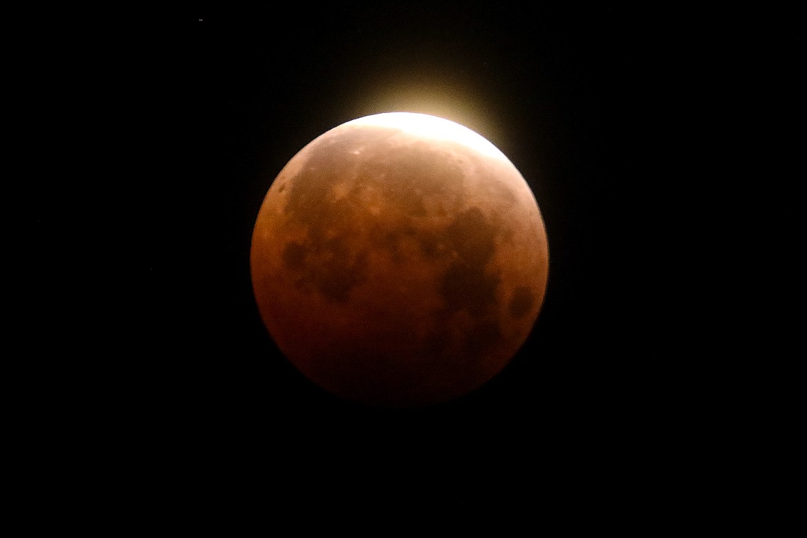 Light shines from a total lunar eclipse over Santa Monica Beach in Santa Monica, Calif., Wednesday, May 26, 2021. (AP Photo/Ringo H.W. Chiu, File)