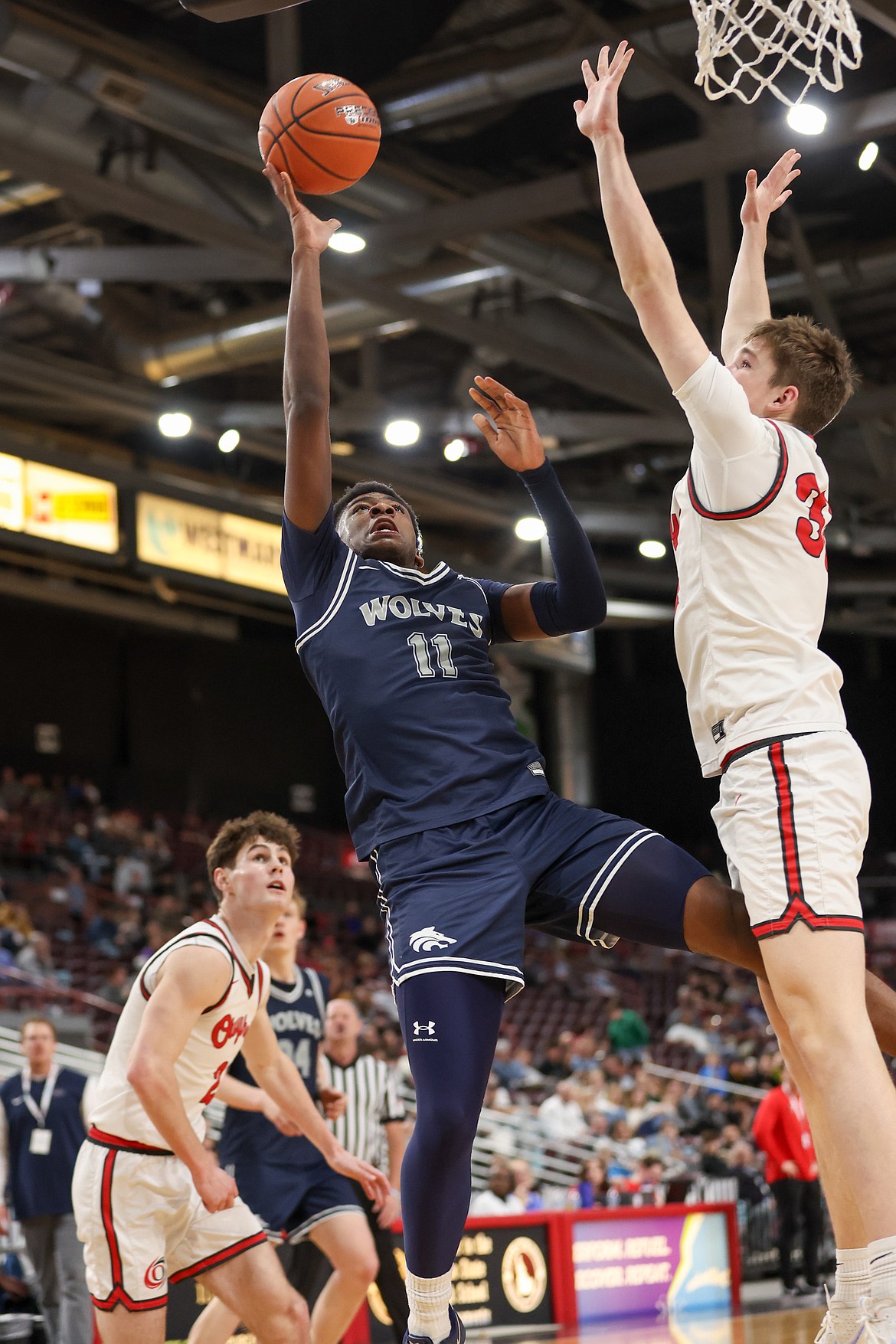 JASON DUCHOW PHOTOGRAPHY
Lake City junior Josh Watson attempts to shoot over Owyhee defender Heath Sasser-Gunson during Saturday's state 6A boys basketball championship game at the Ford Idaho Center in Nampa.