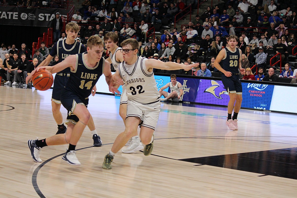 The Lions’ James Robertson (14) tries to beat ACH’s Caden Correia (32) to the lane.