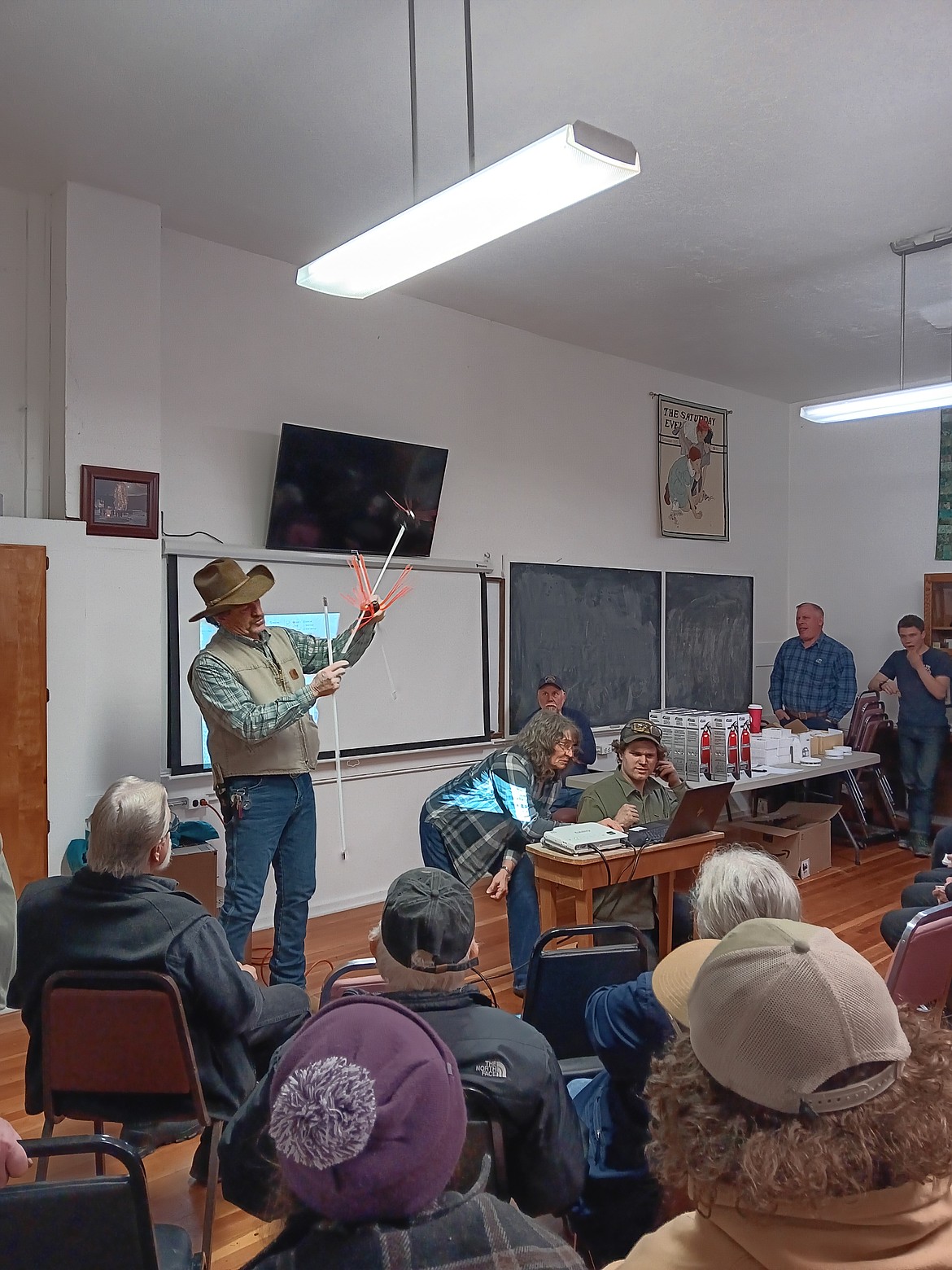 Marlowe Heinz demonstrated a commercial and a homemade stove pipe cleaner to be used inside homes which can prevent flue fires. Here he shows the flexibility of the rods needed to perform the cleaning effectively. (Monte Turner/Mineral Independent)