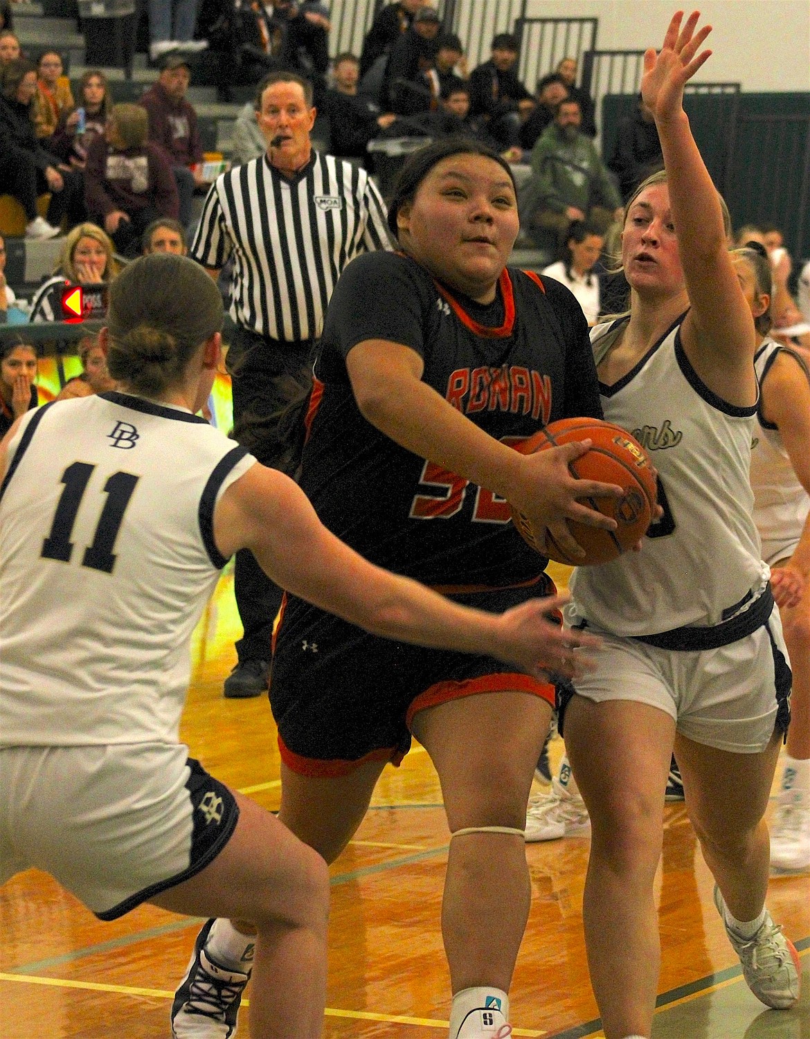 Ronan's Neveah Perez looks to score in the lane against a Dillon defender in the opening game of last weekend's Western A Divisional Tournament in Whitefish. (Kaleb Unger/Leader)