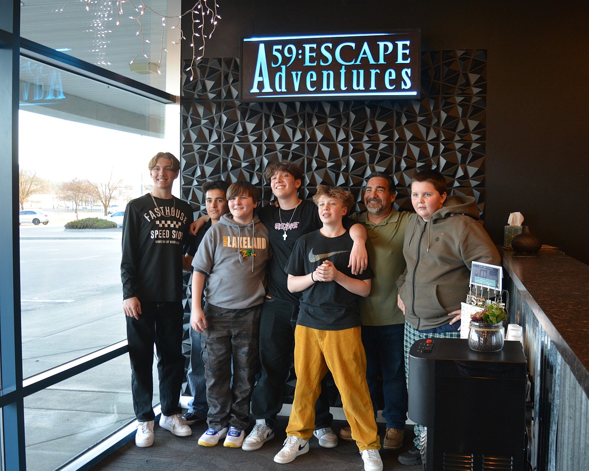 Players celebrate escaping one of the puzzle rooms at 59:Escape Adventures. Pictured: Geno Guzman, Luke Avelos, Mason Williams, Santino Guzman, Carter Smith, Geno Guzman Sr. and Dawson Faber.
