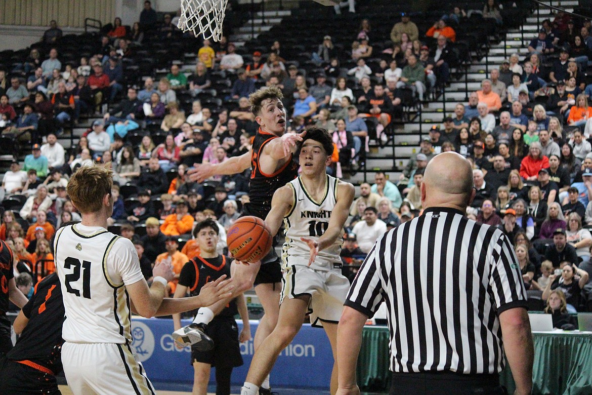 Royal guard Dax Jenks (10) passes the ball to forward Jackson Larson (21) in the Class 1A state tournament game.