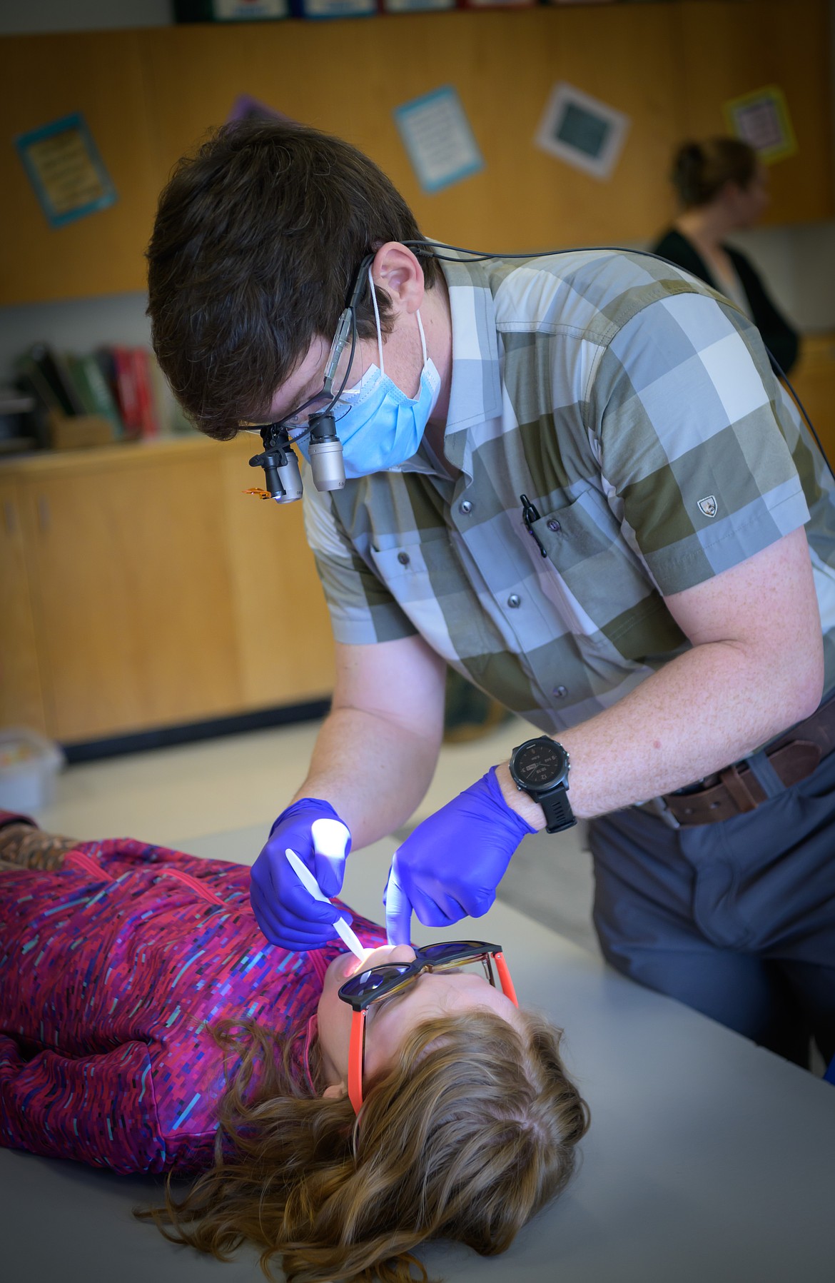 Dr. Blake Sherwood applies sealant to third-grader Anna Brooks during the annual Sealant for Smiles program at the Plains School. (Tracy Scott/Valley Press)