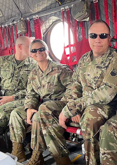 Col. Eileen Iarossi and Col. Keith Jones in a CH-47 Chinook helicopter in Colorado in 2022. They were flying over the Marshall Fire of 2021 to evaluate the damage caused and understand response tactics. (Photo provided)