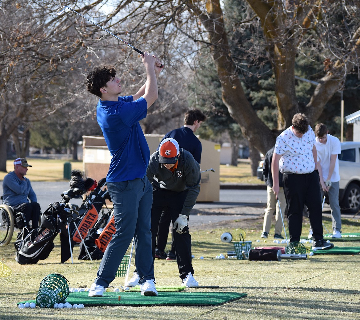 An Ephrata golfer takes down a bucket of balls as he works to repeat a quality swing Friday. Several of the more experienced players have potential to have strong seasons this year, their coach said.