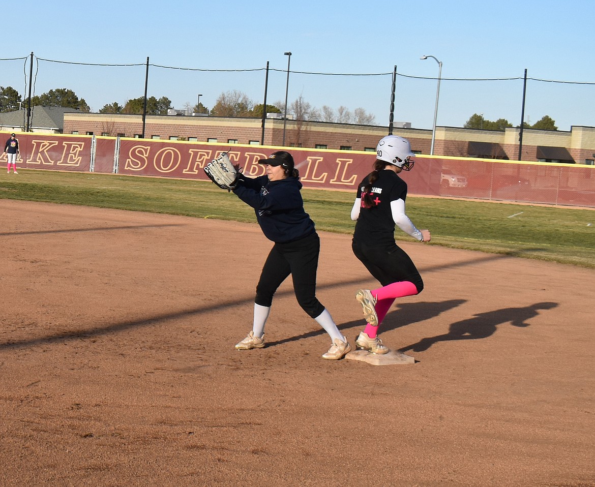 Caitlin Decubber, right, is safe at home despite the best efforts of first baseman Jayylinn Villareal.