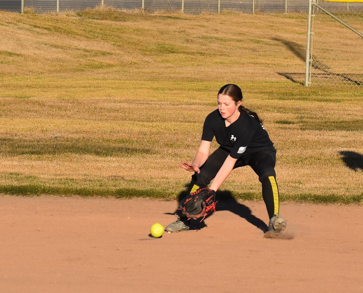 Allie Jensen gets ready to snag a grounder at the Warden Cougars’ softball practice Thursday.