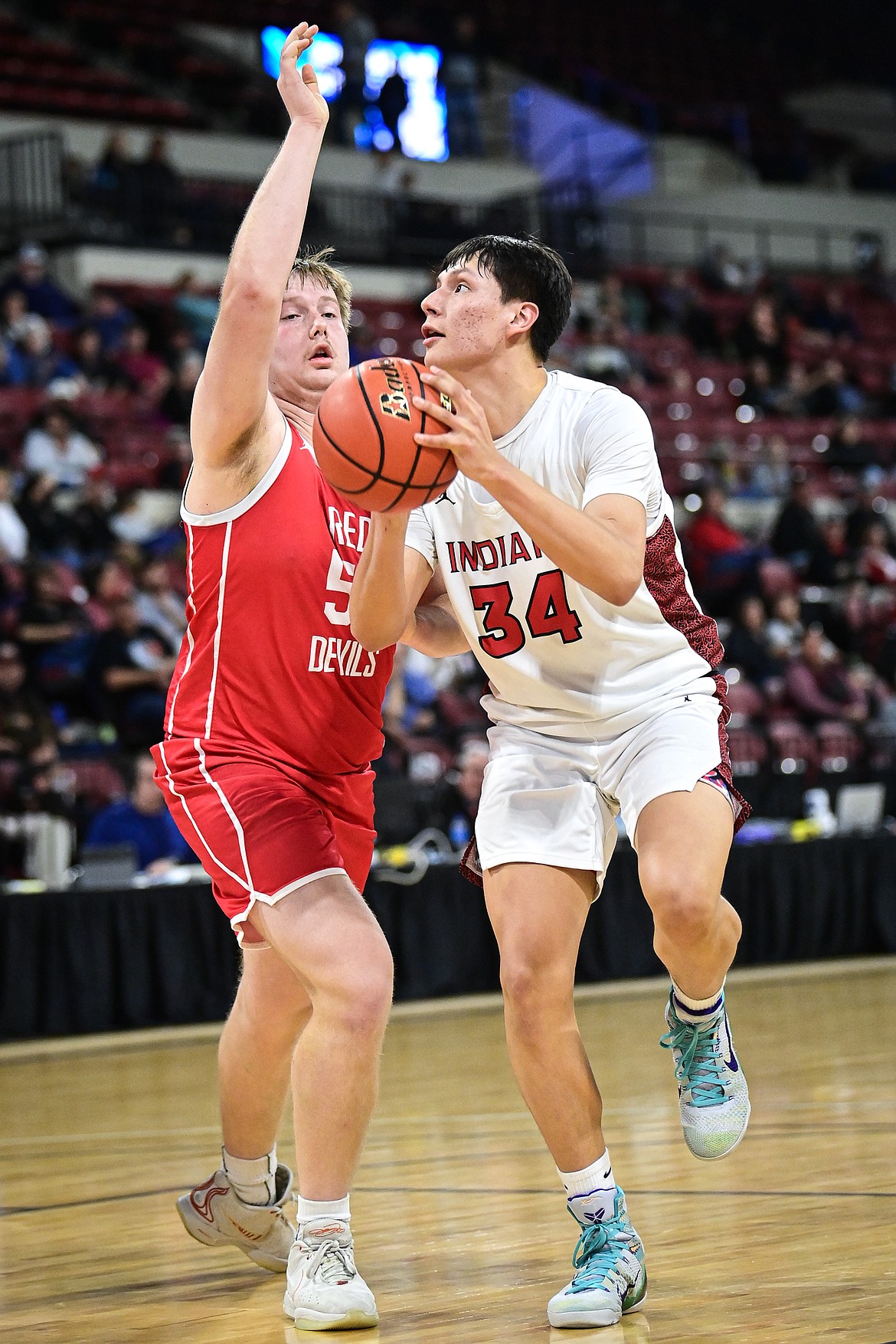 Browning's Tristan Crawford (34) rises to shoot in the first half guarded by Glendive's Levi Eaton (51) at the Class A State Basketball Tournament at the MetraPark First Interstate Arena in Billings on Thursday, March 13. (Casey Kreider/Daily Inter Lake)