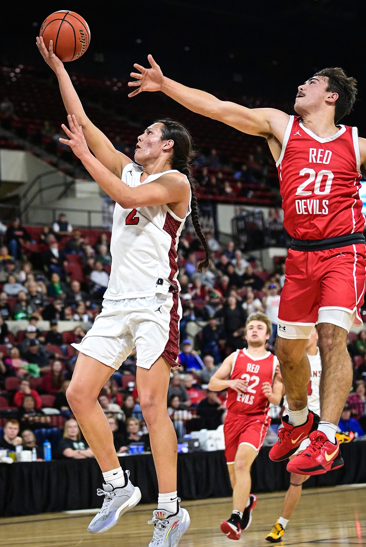 Browning's Jude Reevis (2) drives to the basket in the first half guarded by Glendive's Kason Berry (20) at the Class A State Basketball Tournament at the MetraPark First Interstate Arena in Billings on Thursday, March 13. (Casey Kreider/Daily Inter Lake)