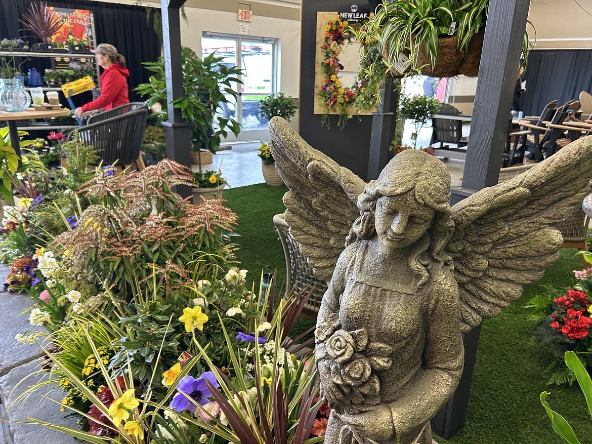 People pass by a patio display by New Leaf Nursery on Thursday that is part of the Home and Garden Show at the Kootenai County Fairgrounds.