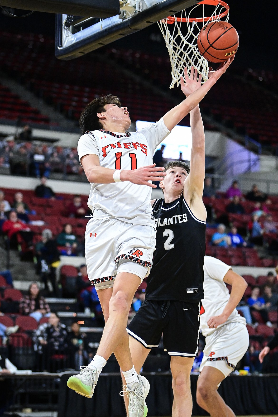 Ronan's Wade Qualtier (11) drives to the basket in the fourth quarter against East Helena at the Class A State Basketball Tournament at the MetraPark First Interstate Arena in Billings on Friday, March 14. (Casey Kreider/Daily Inter Lake)