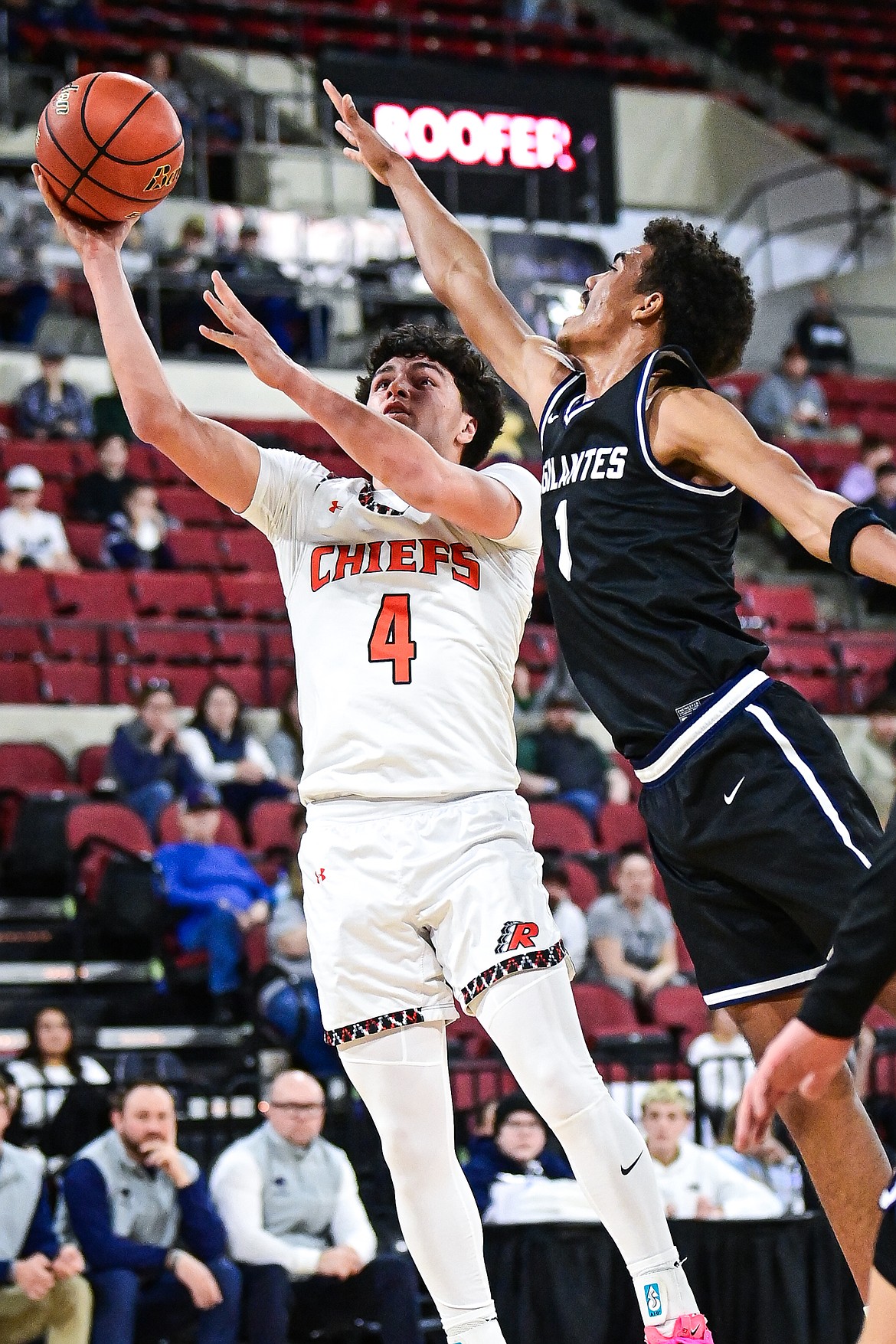 Ronan's Kolby Finley (4) drives to the basket guarded by East Helena's Deondray Ellis (1) in the first half at the Class A State Basketball Tournament at the MetraPark First Interstate Arena in Billings on Friday, March 14. (Casey Kreider/Daily Inter Lake)