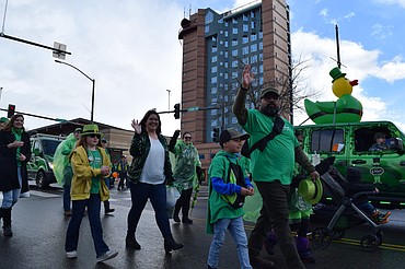Families with ICCU wave to paradegoers along Sherman Avenue on Saturday.