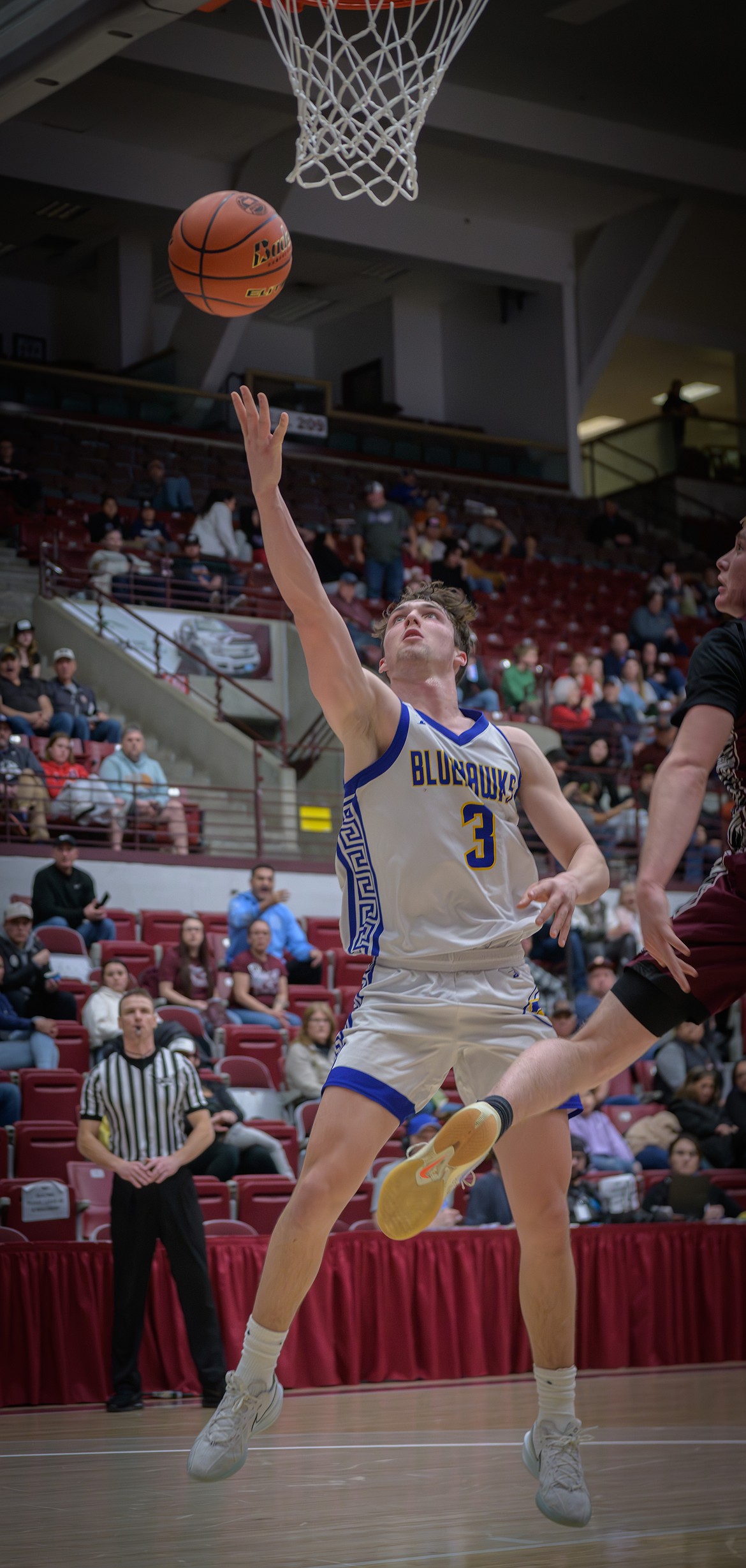 Senior forward Bryson LeCoure drops in a two-pointer during the Blue Hawks' first round game at the State B championship in Missoula. (Tracy Scott/Valley Press)