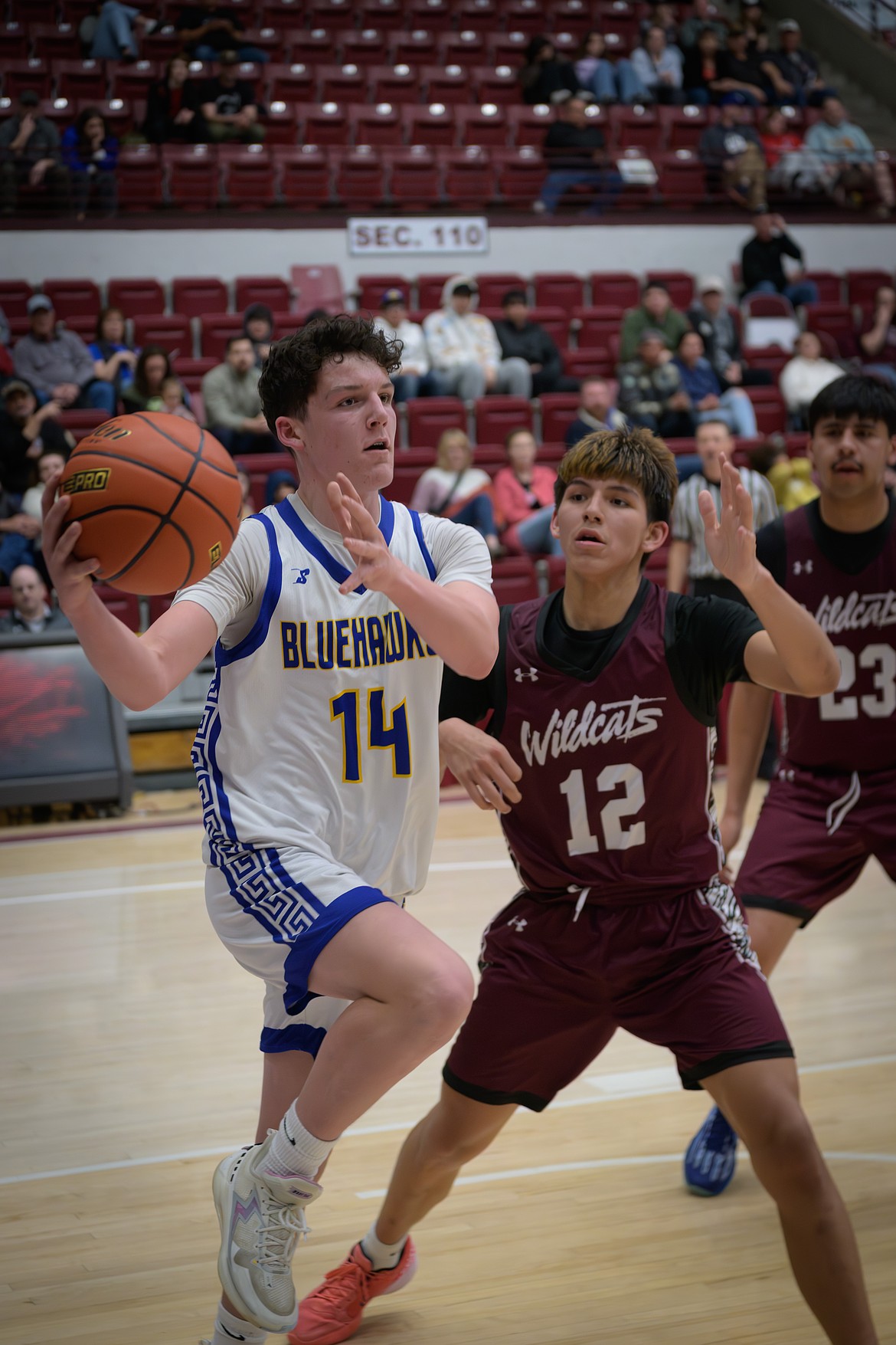 Thompson Falls forward Kellen LeCoure (14) is guarded by Harlem's Nathan Blackwolf during their first-round state playoff game this past week in Missoula. (Tracy Scott, Valley Press)