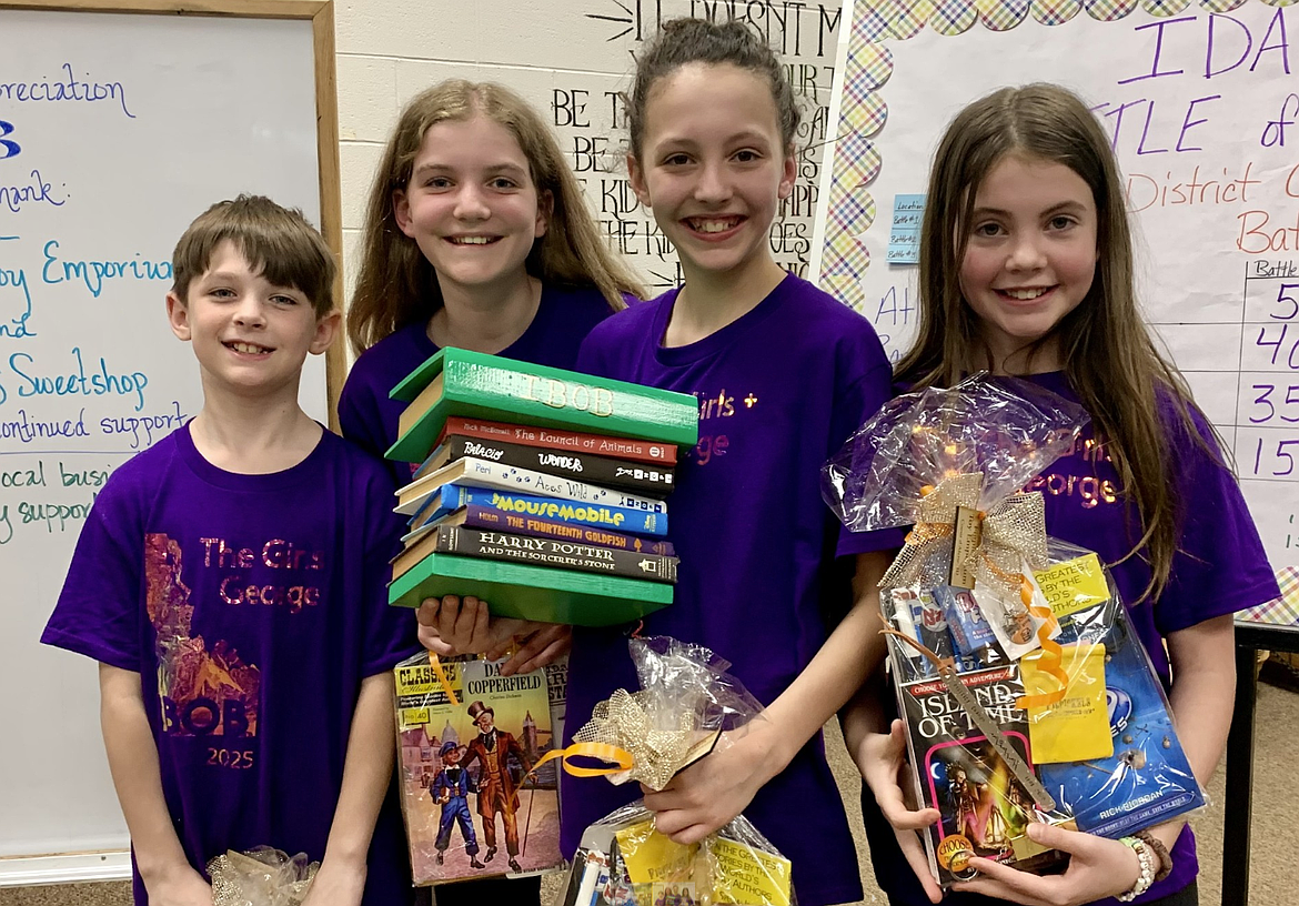Sorensen Magnet School of the Arts and Humanities' team, The Girls Plus George, proudly displays the traveling Idaho Battle of the Books trophy after taking first place at the district Idaho Battle for the Books competition Tuesday at Ramsey Magnet School of Science. From left: George Jerkins, Birdie Bailey, Liv Mickelson and Keeva Rumsey.