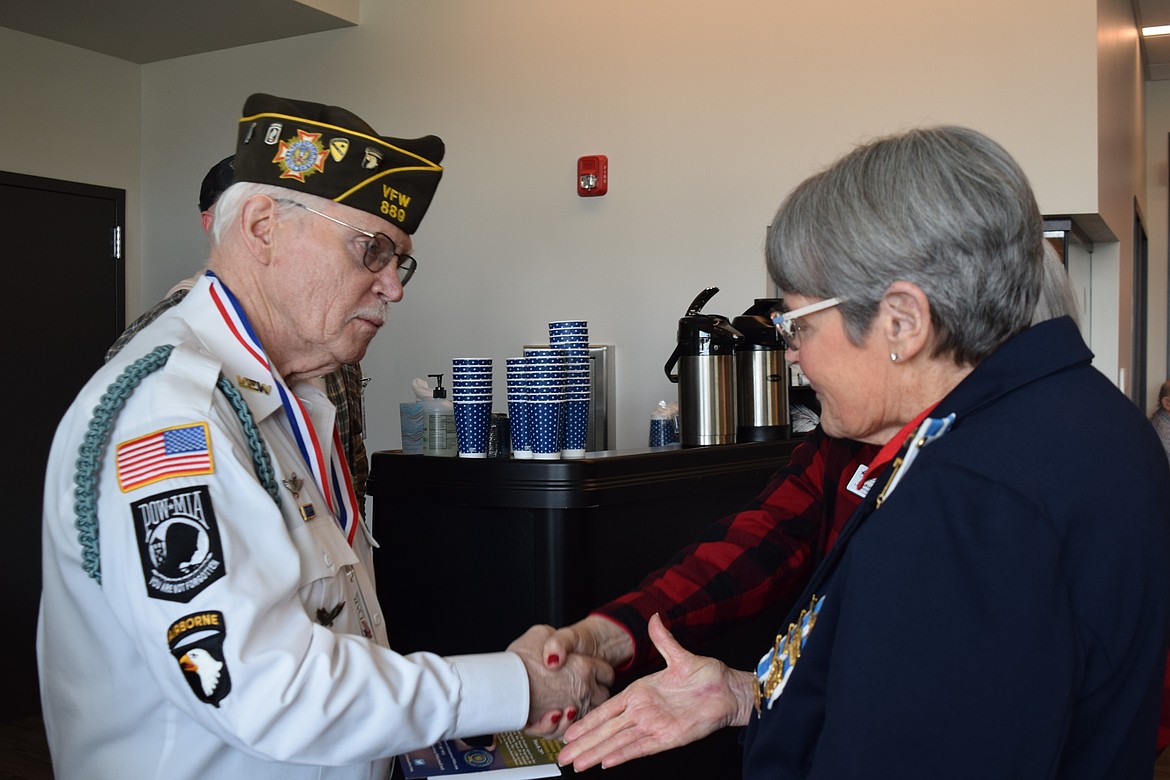 Bob Martin shakes hands with DAR members after being presented with a Vietnam Veteran Lapel Pin Saturday morning. Martin served four tours in Vietnam, earning three Purple Hearts and a Silver Star Medal.