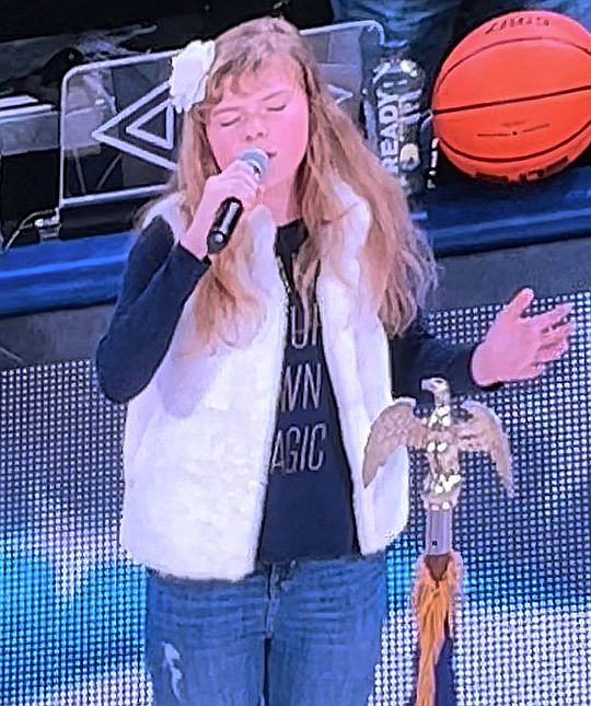 Seen here in 2022, then-sixth grader Jordynn Walker appears on a jumbotron as she sings the national anthem before a Gonzaga basketball game. The young vocalist continues to sing at area sporting events as her performance portfolio expands.
