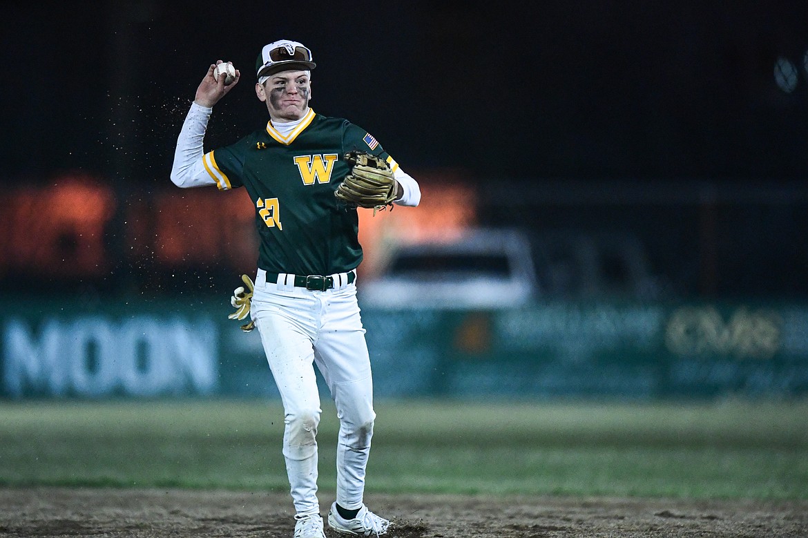 Whitefish second baseman Drew Queen (27) throws to first after fielding a grounder against Columbia Falls at Sapa-Johnsrud Memorial Field on Friday, April 4. (Casey Kreider/Daily Inter Lake)
