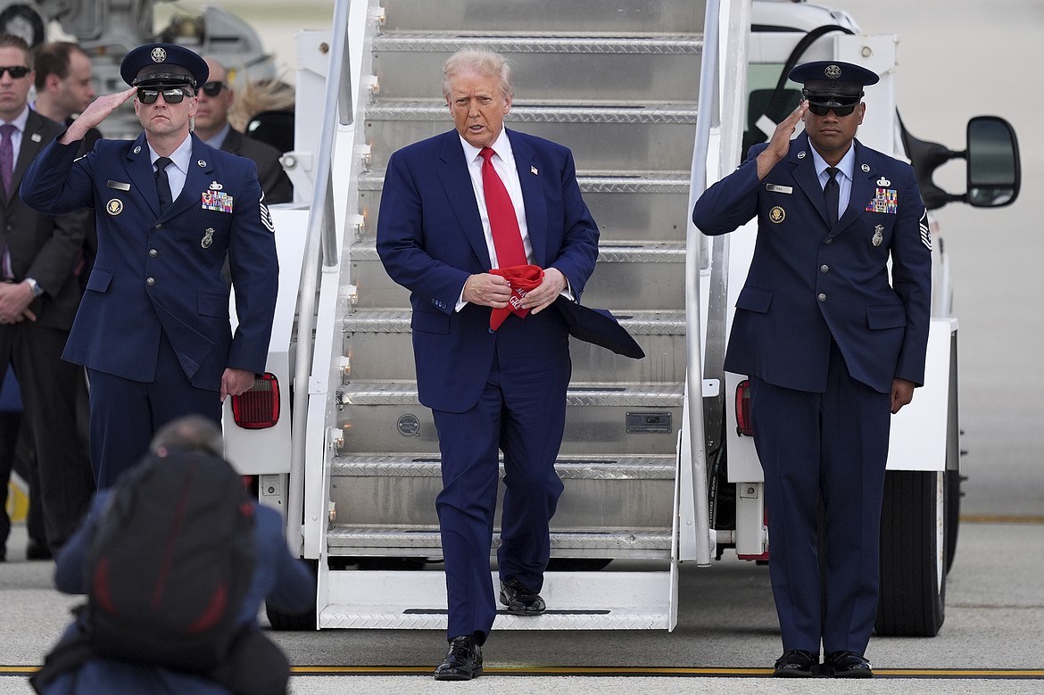 President Donald Trump, center, arrives on Air Force One at Miami International Airport, Thursday, April 3, 2025, in Miami. (AP Photo/Rebecca Blackwell)