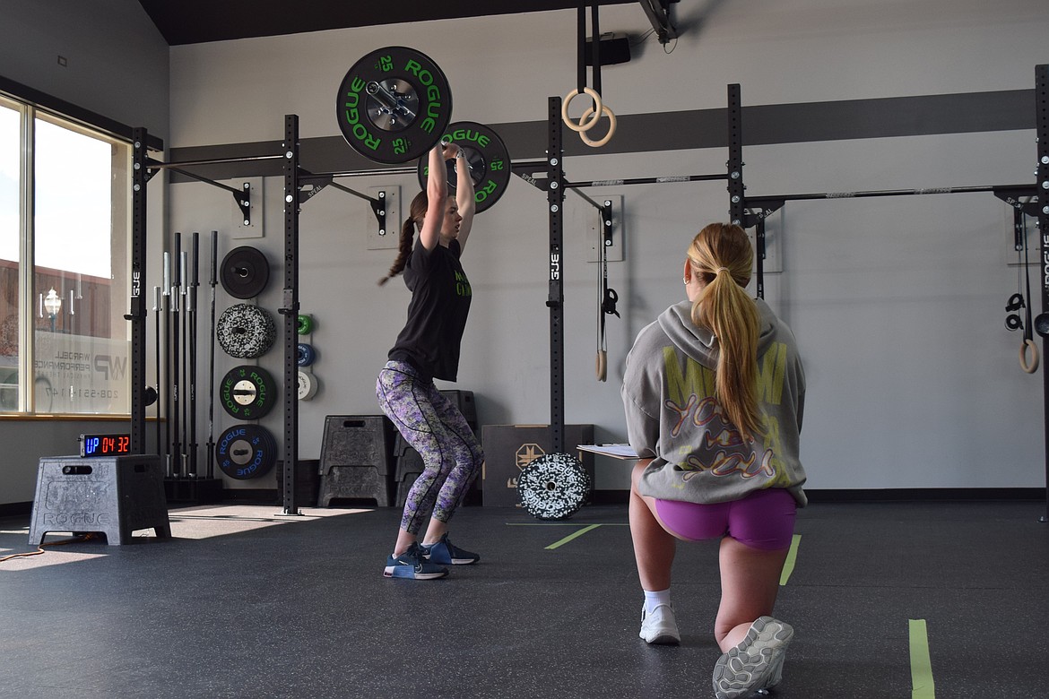 Coach Tori Dyson coaches an athlete at Lakeside CrossFit.