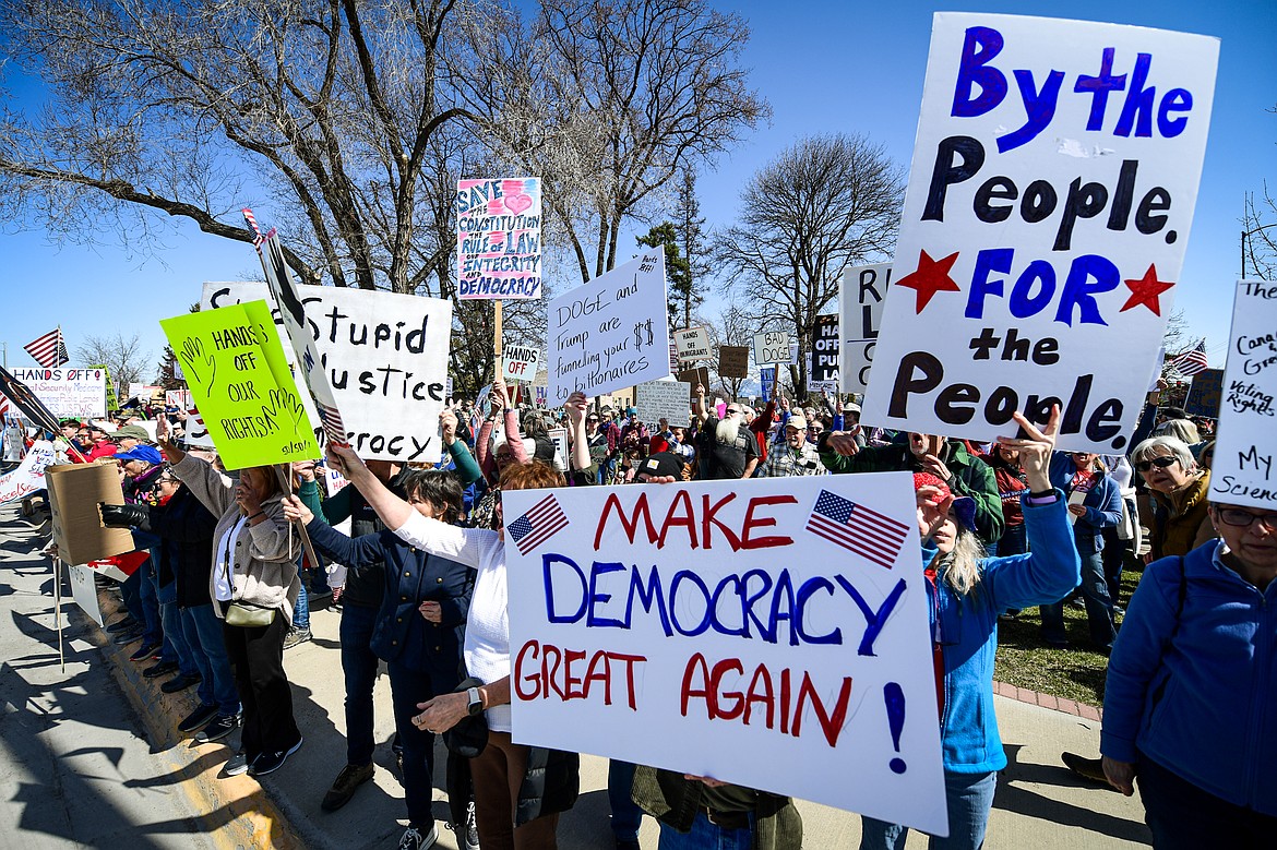 Demonstrators gather for a "Hands Off" protest at Depot Park after making their way up the length of Main Street in Kalispell on Saturday, April 5. (Casey Kreider/Daily Inter Lake)