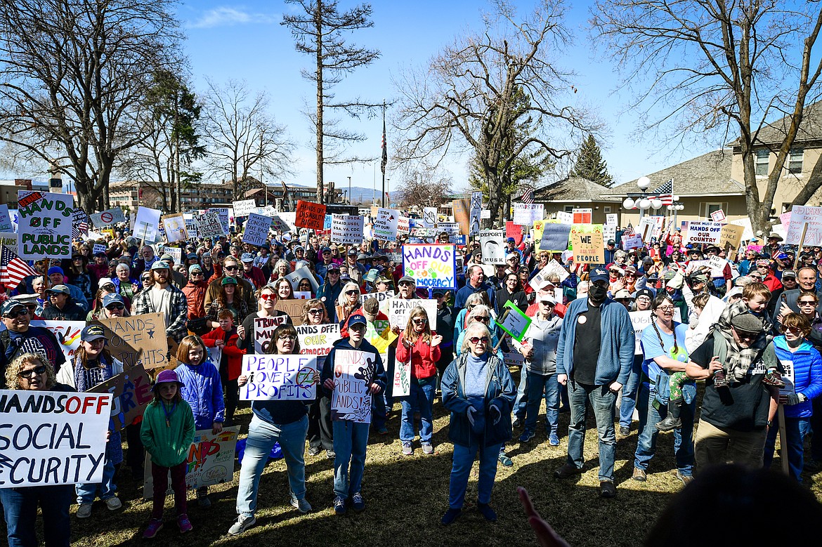 Demonstrators gather for a "Hands Off" protest at Depot Park after making their way up the length of Main Street in Kalispell on Saturday, April 5. (Casey Kreider/Daily Inter Lake)