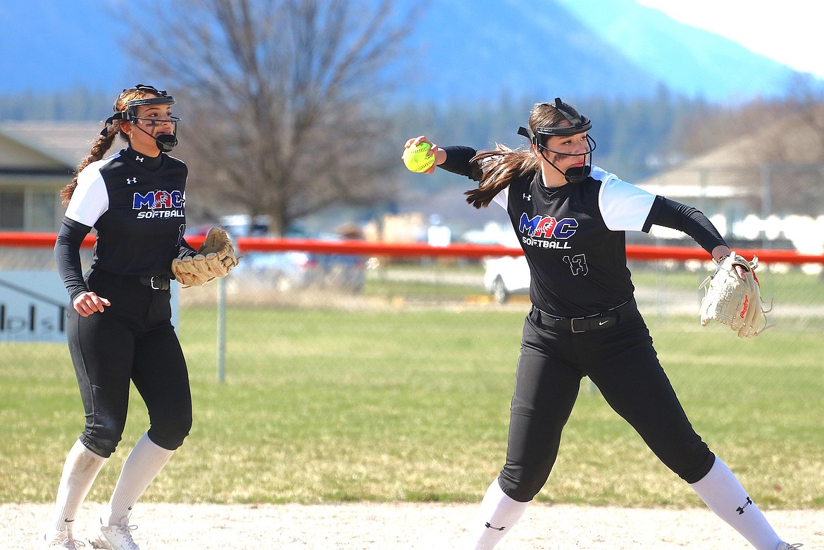 Junior Alecia Steele throws to first with sophomore Avia Lee backing her up during Mission-Arlee-Charlo's game against Plains last Friday. (Caroline Roesch photo)
