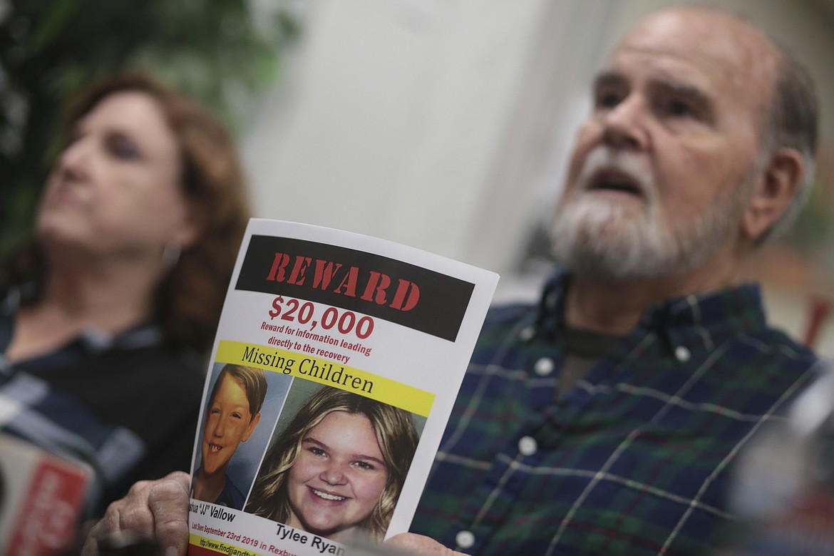 Larry Woodcock speaks to media members at the Rexburg Standard Journal Newspaper in Rexburg, Idaho on Jan. 7, 2020, while holding a reward flyer for Joshua Vallow and Tylee Ryan. (John Roark/The Idaho Post-Register via AP, File)