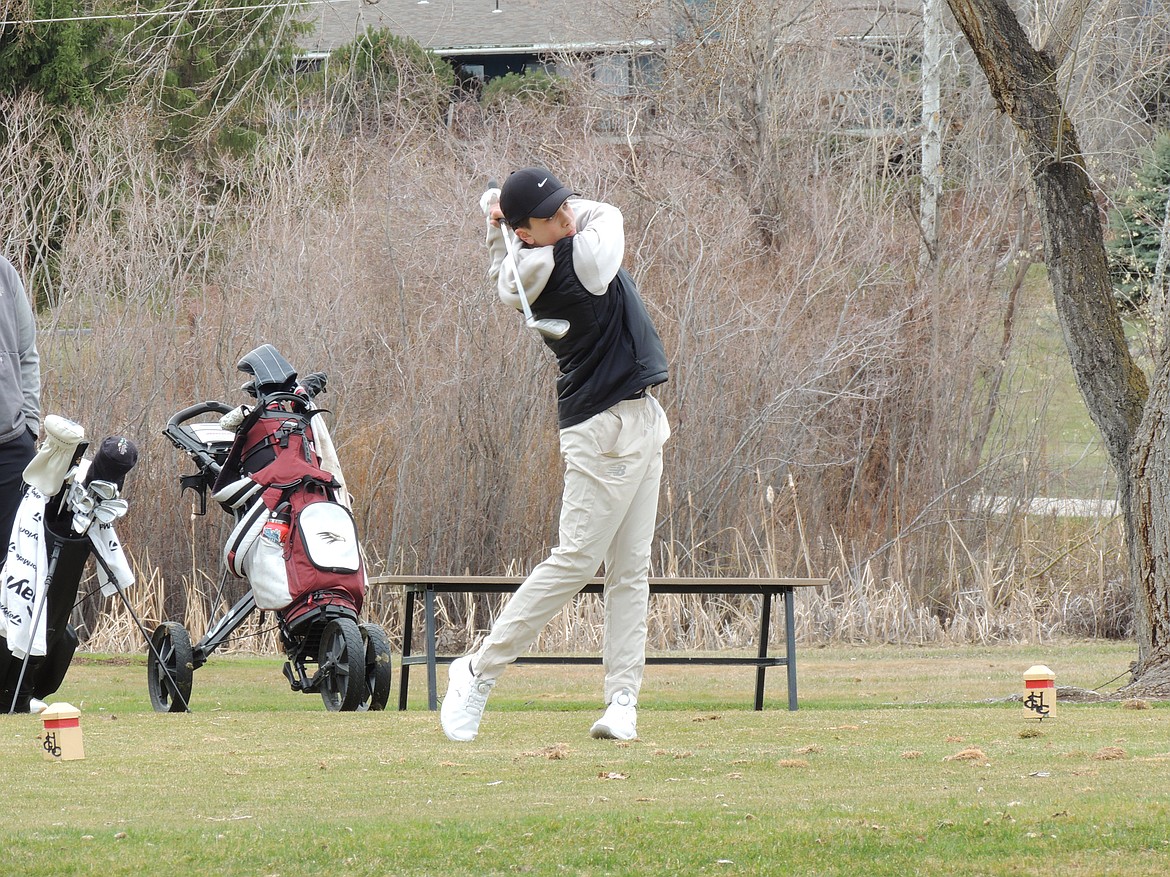 Thompson Falls golfer Tristan Kelly hits a tee shot during the Florence-Darby Invitational at Hamilton Golf Club this past week.  (Photo by Doree Thilmony)