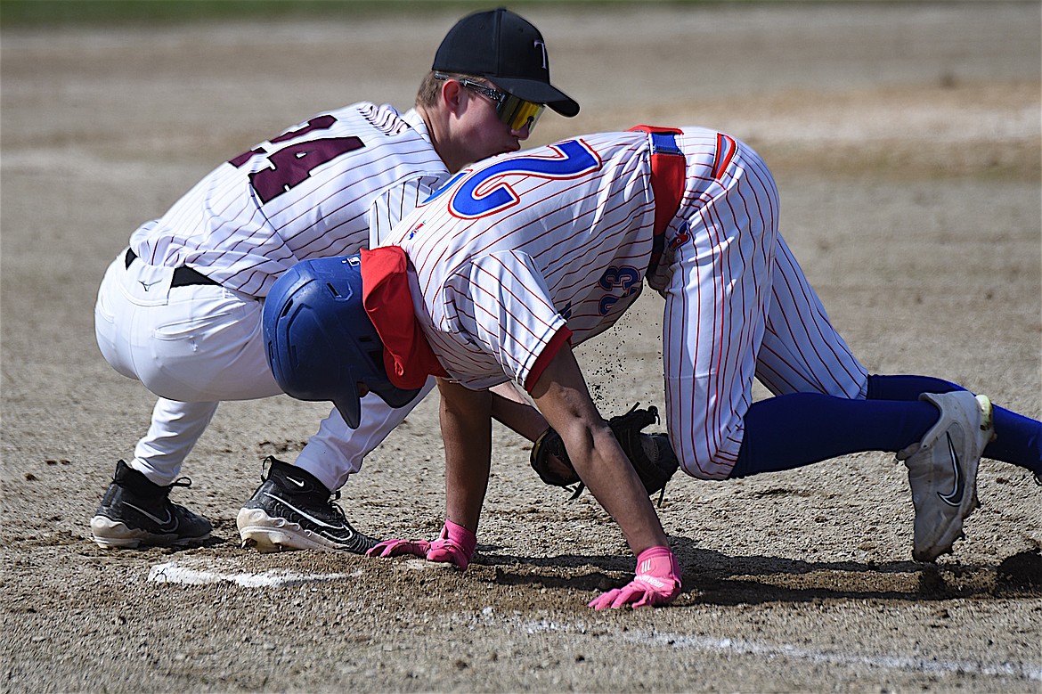 Bigfork's Rye Rodriguez gets back to first base ahead of the tag of Troy first baseman Tommy Martin during their game Saturday, April 5, 2025. (Scott Shindledecker/The Western News)