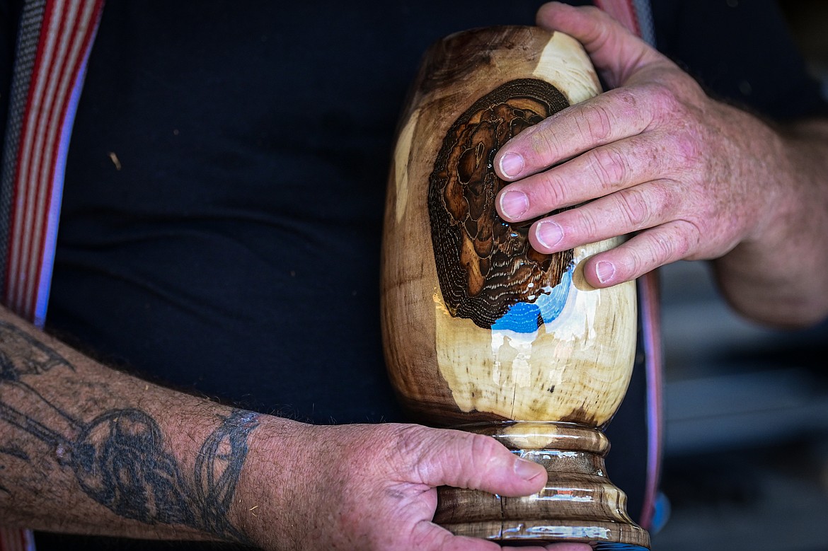 Calvin St. Peter holds a vase made from a piece of black walnut at Mug Man Woodworking in Kalispell on Tuesday, April 8. (Casey Kreider/Daily Inter Lake)