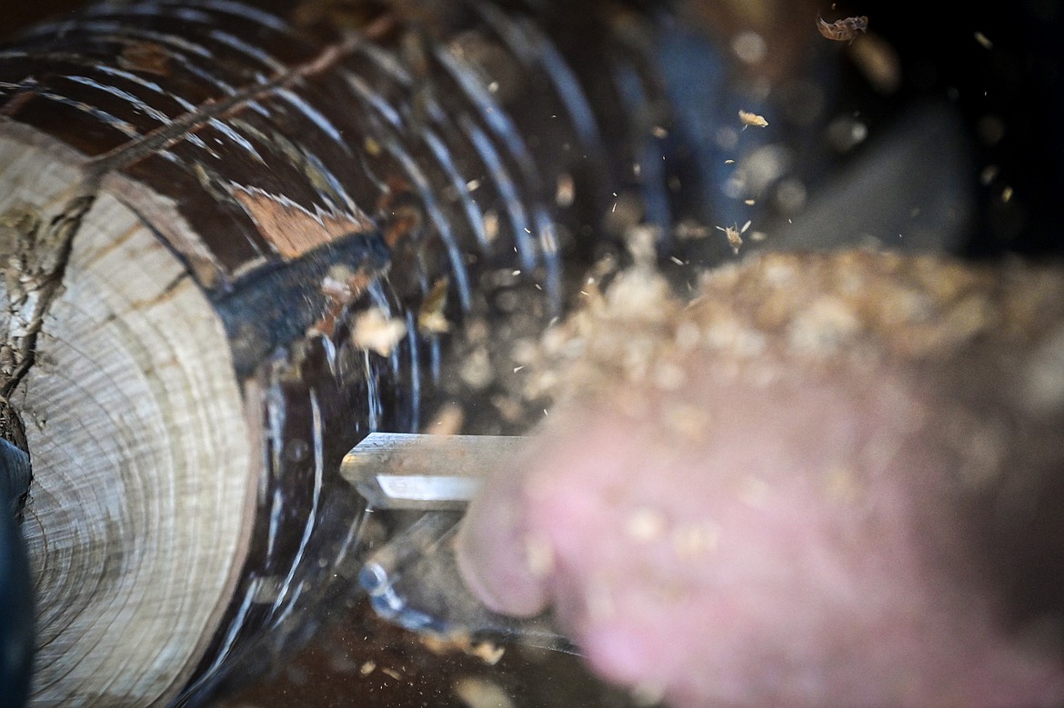 Calvin St. Peter carves a piece of cherry wood using a lathe to create one of his custom pieces at Mug Man Woodworking on Tuesday, April 8. (Casey Kreider/Daily Inter Lake)