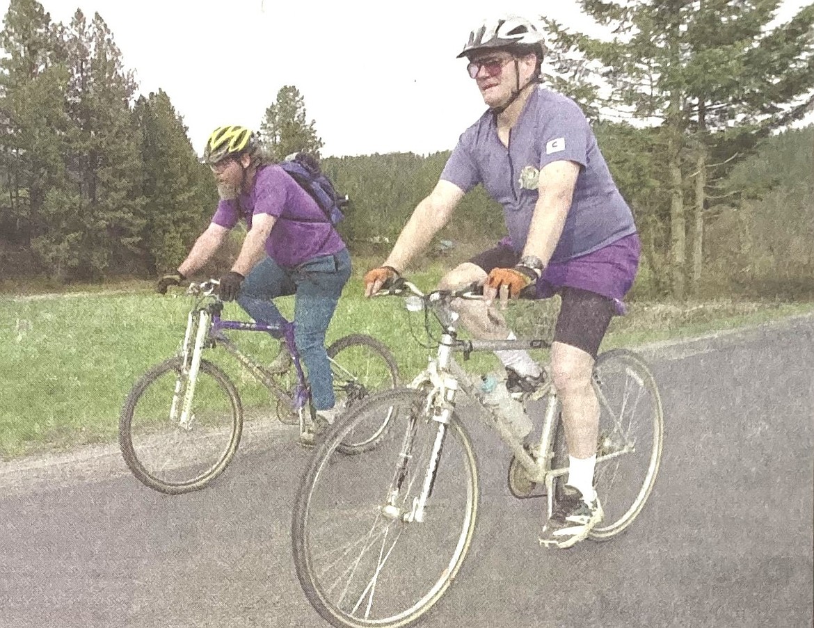 Joe Peak, right, and Larry Halley ride bikes to support a rails-to-trails project.