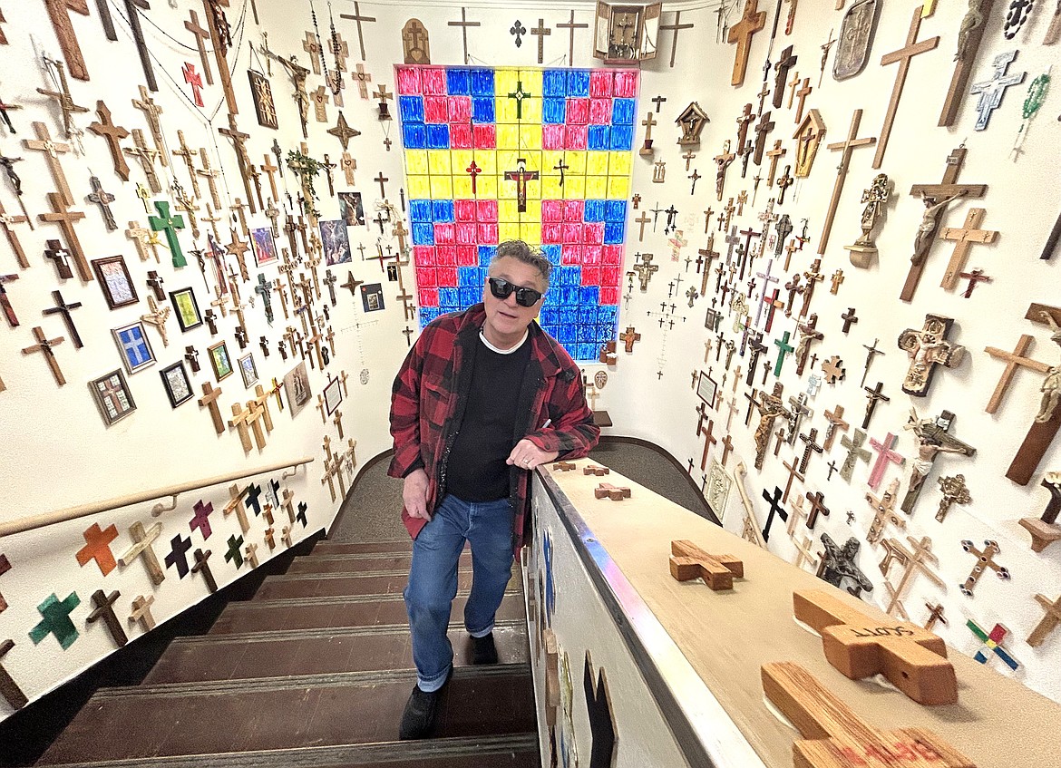 John Kastelic stands on the stairs in the Cove of Crosses.