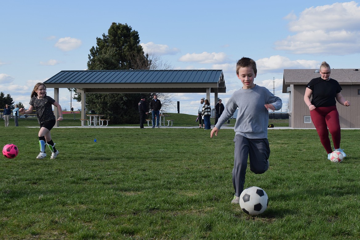 Maddox Tribble, 7 (center), Davida Jo Basye-Reed, 7 (left) and Dallyce Reed, 13 (right) practice their soccer skills at Croffoot Park in Hayden.