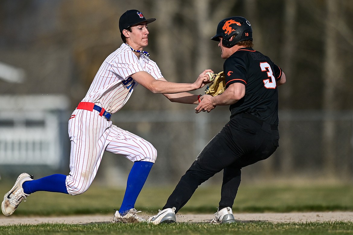 Bigfork third baseman Hayden Mayer (8) tags Eureka's Rogan Lytle (3) after fielding a grounder in the hole at ABS Park on Thursday, April 10. (Casey Kreider/Daily Inter Lake)