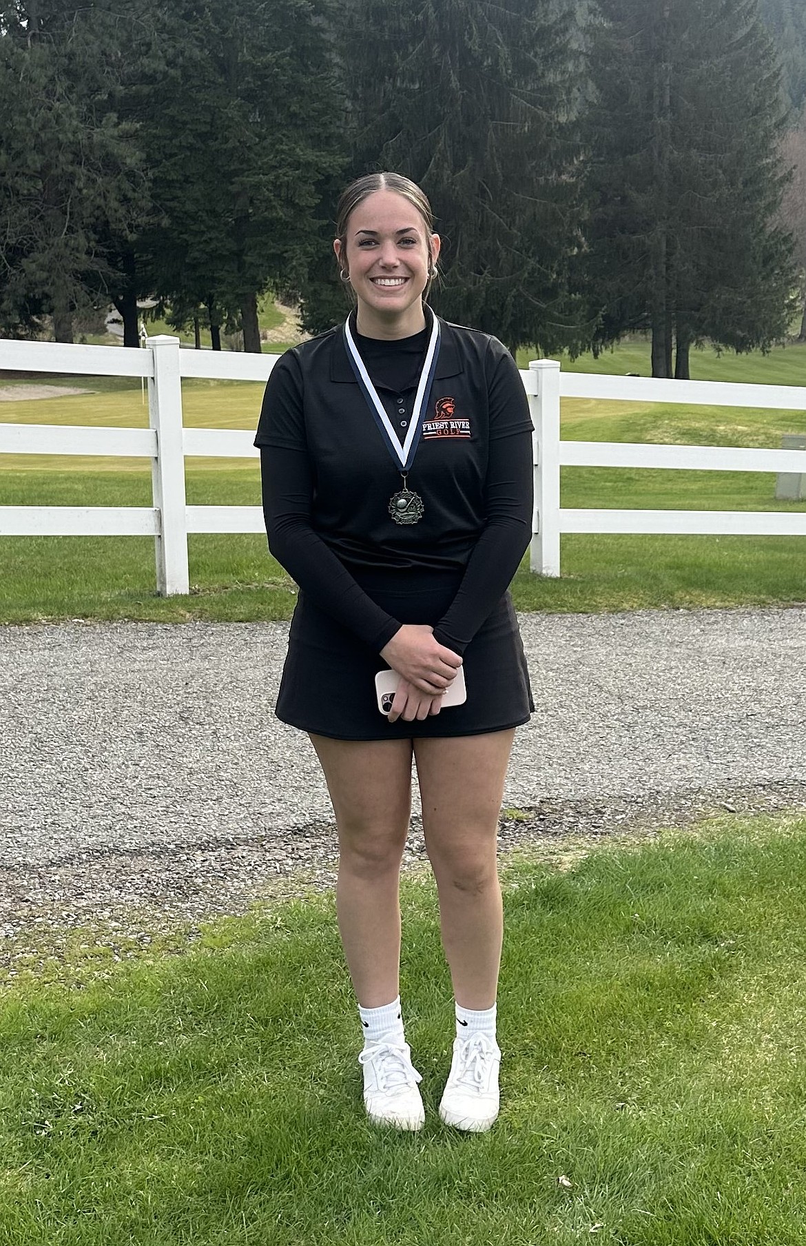 Priest River High senior Paityn Yount is all smiles after receiving her silver medal at the Bonners Ferry Invite held Thursday at the Mirror Lake Golf Course.