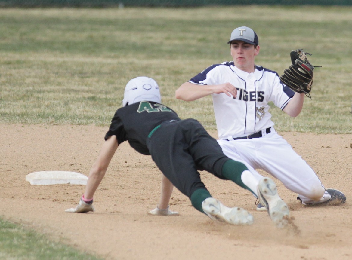 MARK NELKE/Press
Timberlake second baseman Zach Blansfield (19) prepares to tag out Landen Holmes of St. Maries on a steal attempt in the second game of a doubleheader Thursday at Timberlake.