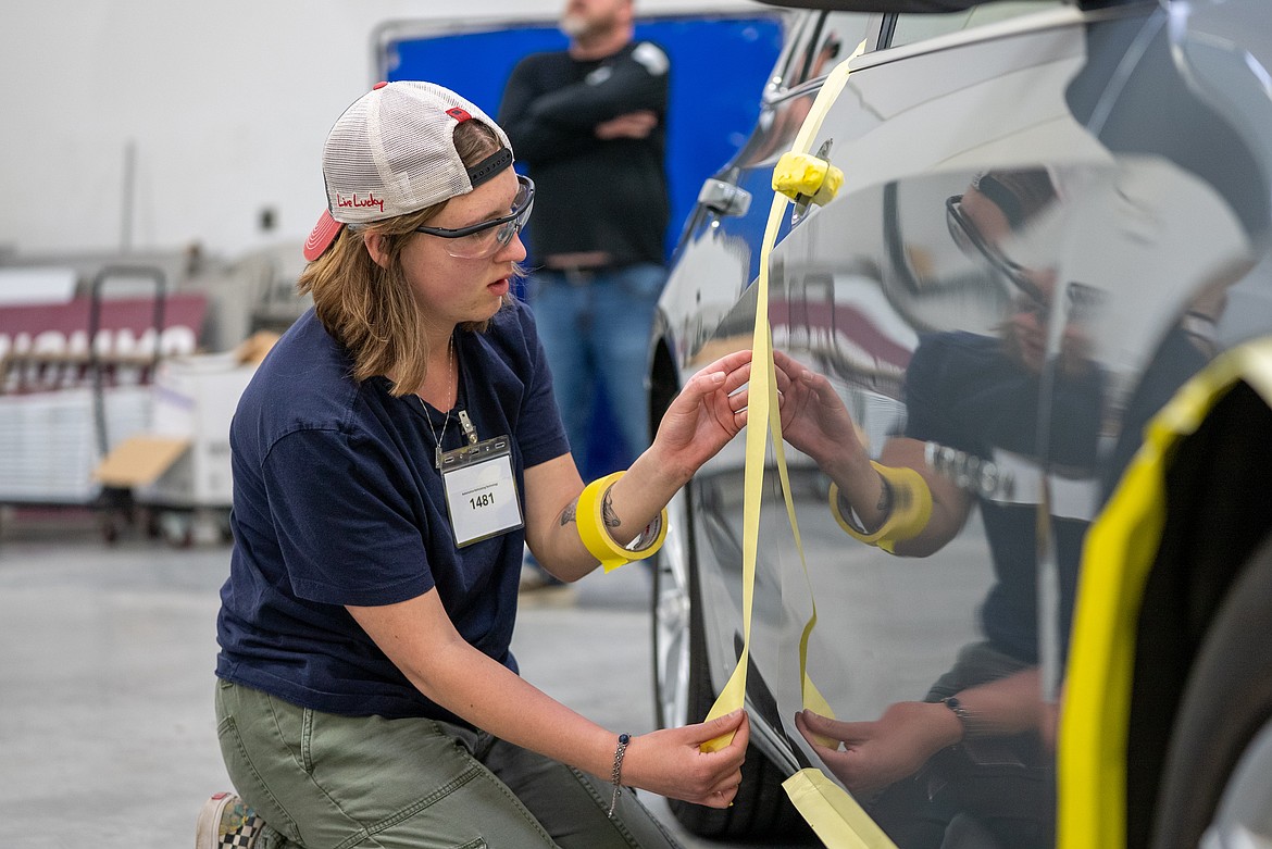North Idaho College dual credit student Allie Van Ditto places masking tape on a vehicle as part of a SkillsUSA competition on Tuesday at the College of Western Idaho’s Micron Building in Nampa.