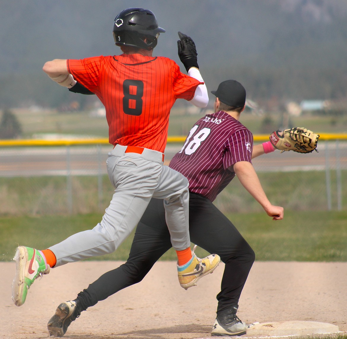 Ronan senior Treysin Sinclair leaps for first base in a battle against Troy. (Kaleb Unger/Leader)