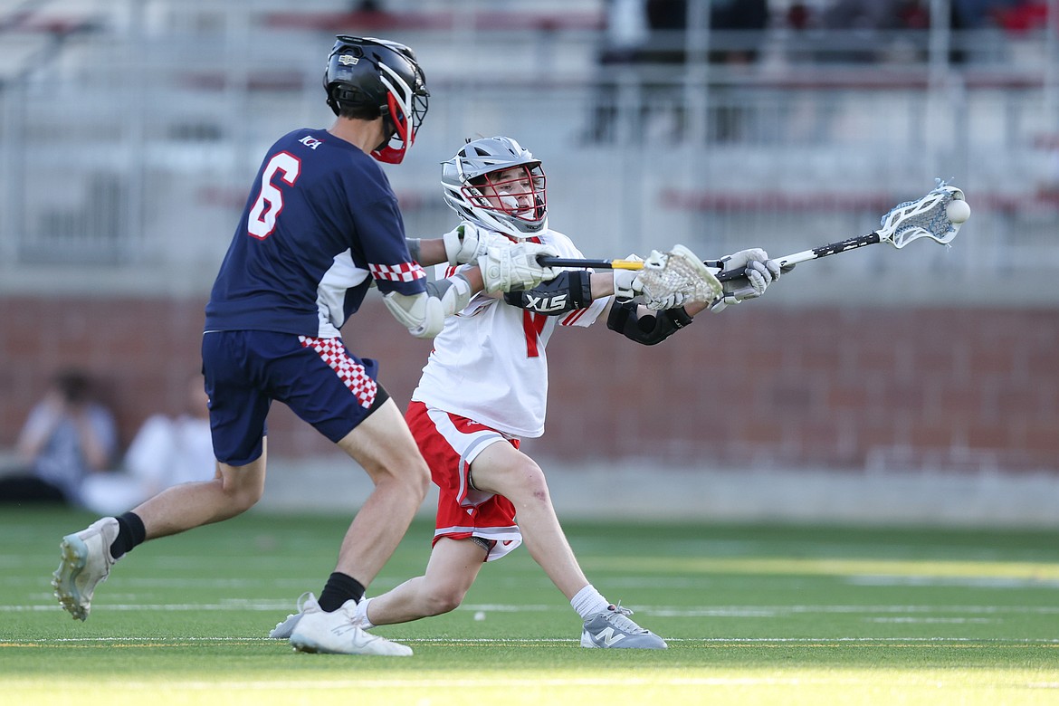 Sandpoint High sophomore Kohta Fisher slings a shot towards the Cristeros' net during the Bulldogs' 16-1 IHSLL North Division win over Immaculate Conception Academy on Monday night at War Memorial Field.