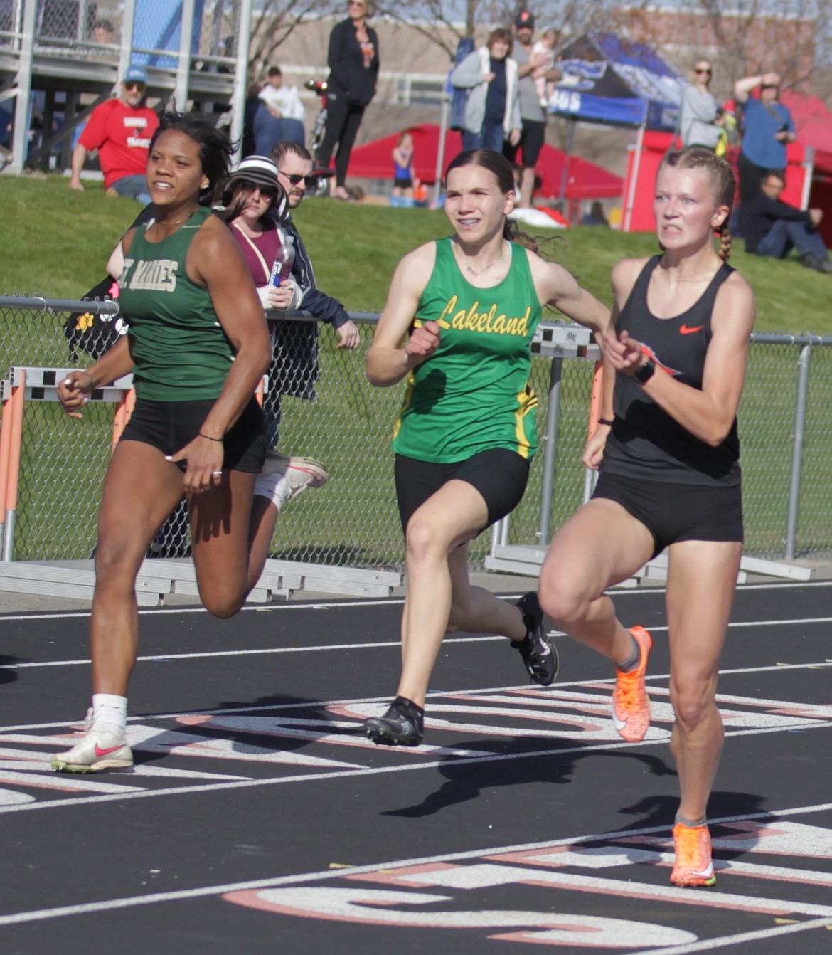 JASON ELLIOTT/Press
Post Falls senior Chloe Van Volkinburg looks to extend her lead in the girls 100-meter dash as Lakeland sophomore Sapphire Ruelle and St. Maries sophomore Raevyn Yearout close in during Tuesday's Christina Finney Co-Ed Relays at Post Falls High.