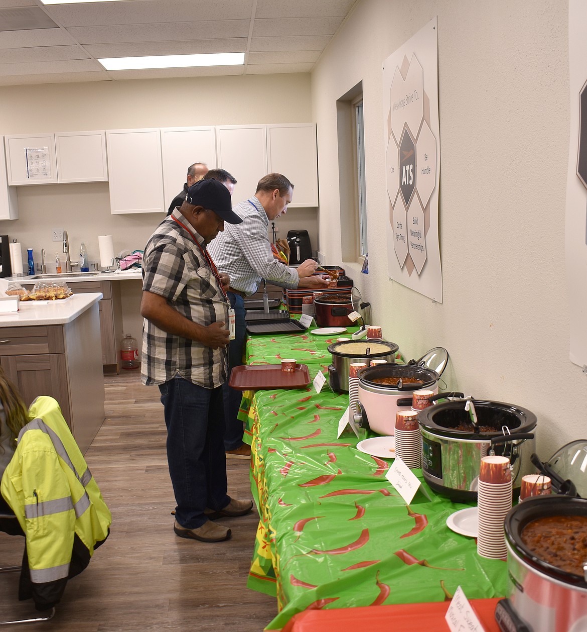 Presidential Representative Prasad Talaiver leads the way as the judges at Greenpoint Technologies’ chili cook-off serve up samples of eight different chilies.