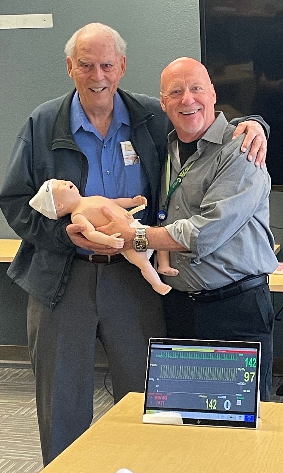 Chris Stahler, right, and Dave Shanley, Confluence clinical development and eLearning manager, with a simulation mannequin purchased with the help of a donation from Stahler.