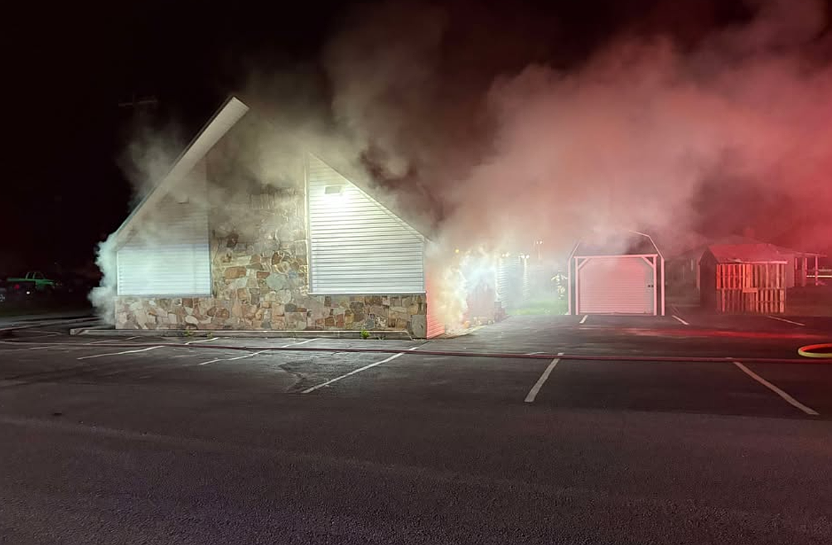 Smoke pours from the windows of the Seventh Day Adventist Church in Osburn on Thursday morning. The accidental fire was caused by a failed heating element in the church's baptismal.